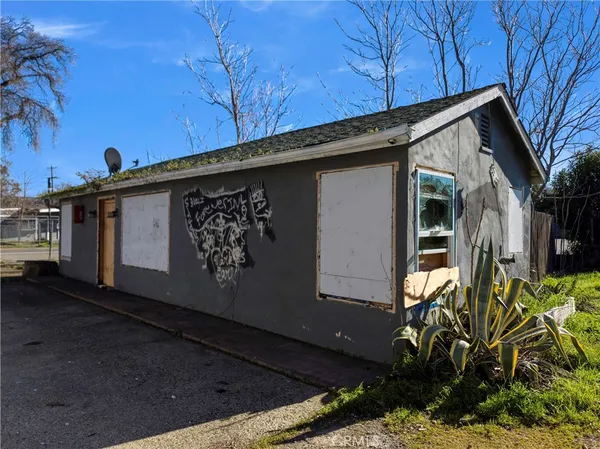 a black house with trees in front of it