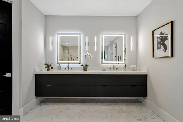 a bathroom with a sink double vanity and a shower