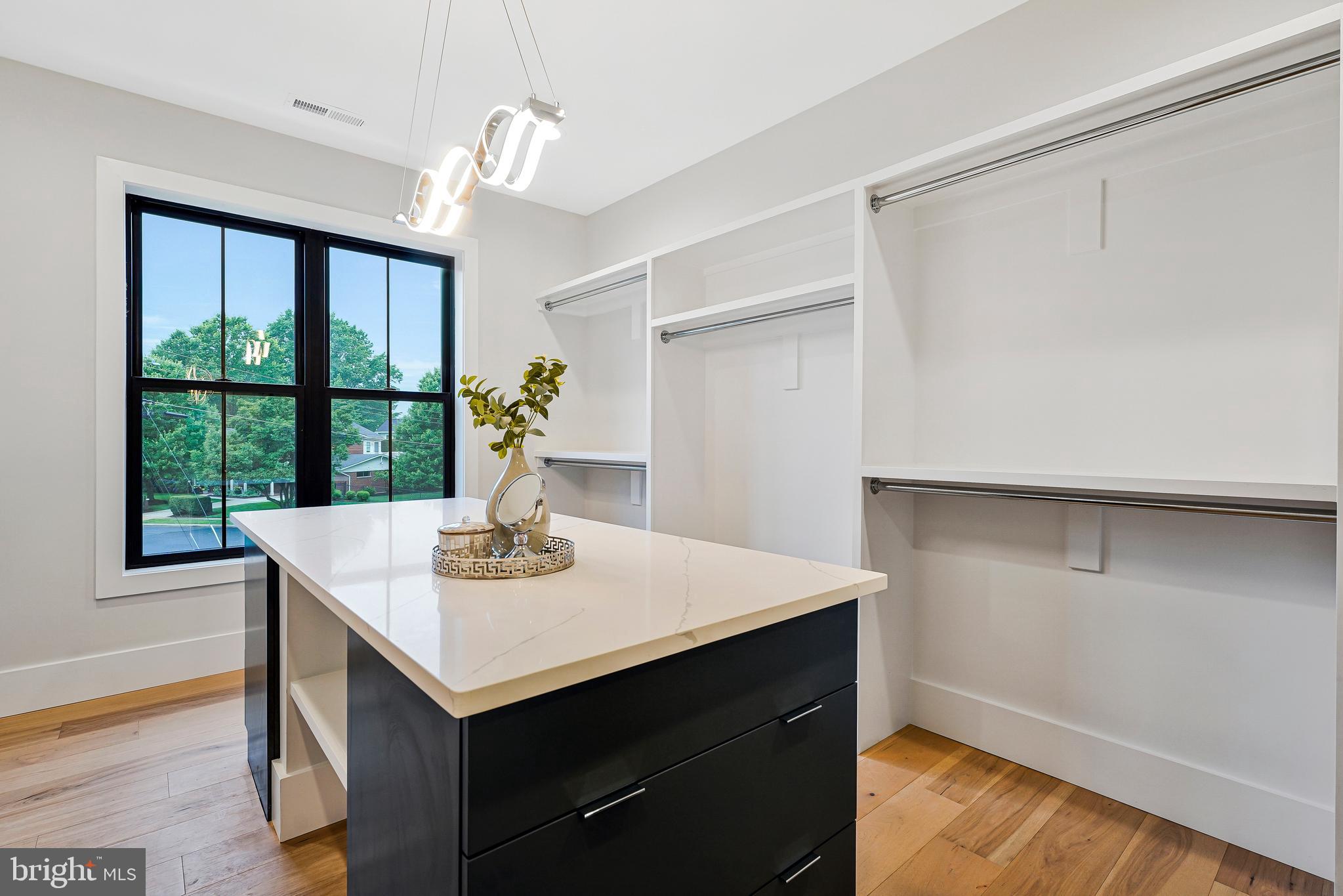 11410 Waples Mill Road Oakton, VA 22124 - Photo 18 of 104 a view of kitchen island with cabinets and wooden floor
