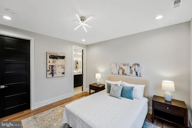 a bathroom with a sink a toilet a shower and a mirror