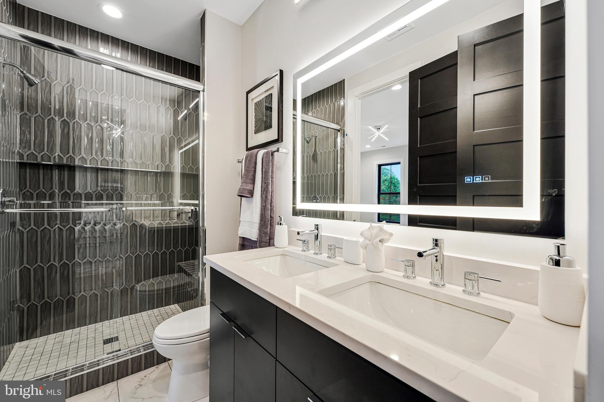 11410 Waples Mill Road Oakton, VA 22124 - Photo 23 of 104 a bathroom with a sink double vanity and a shower