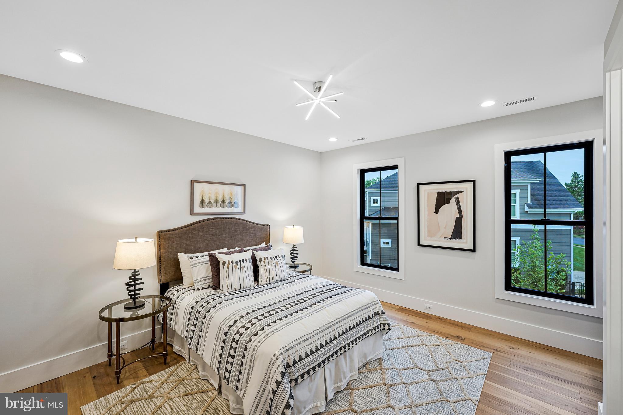 11410 Waples Mill Road Oakton, VA 22124 - Photo 25 of 104 a bedroom with a large bed and a painting on the wall