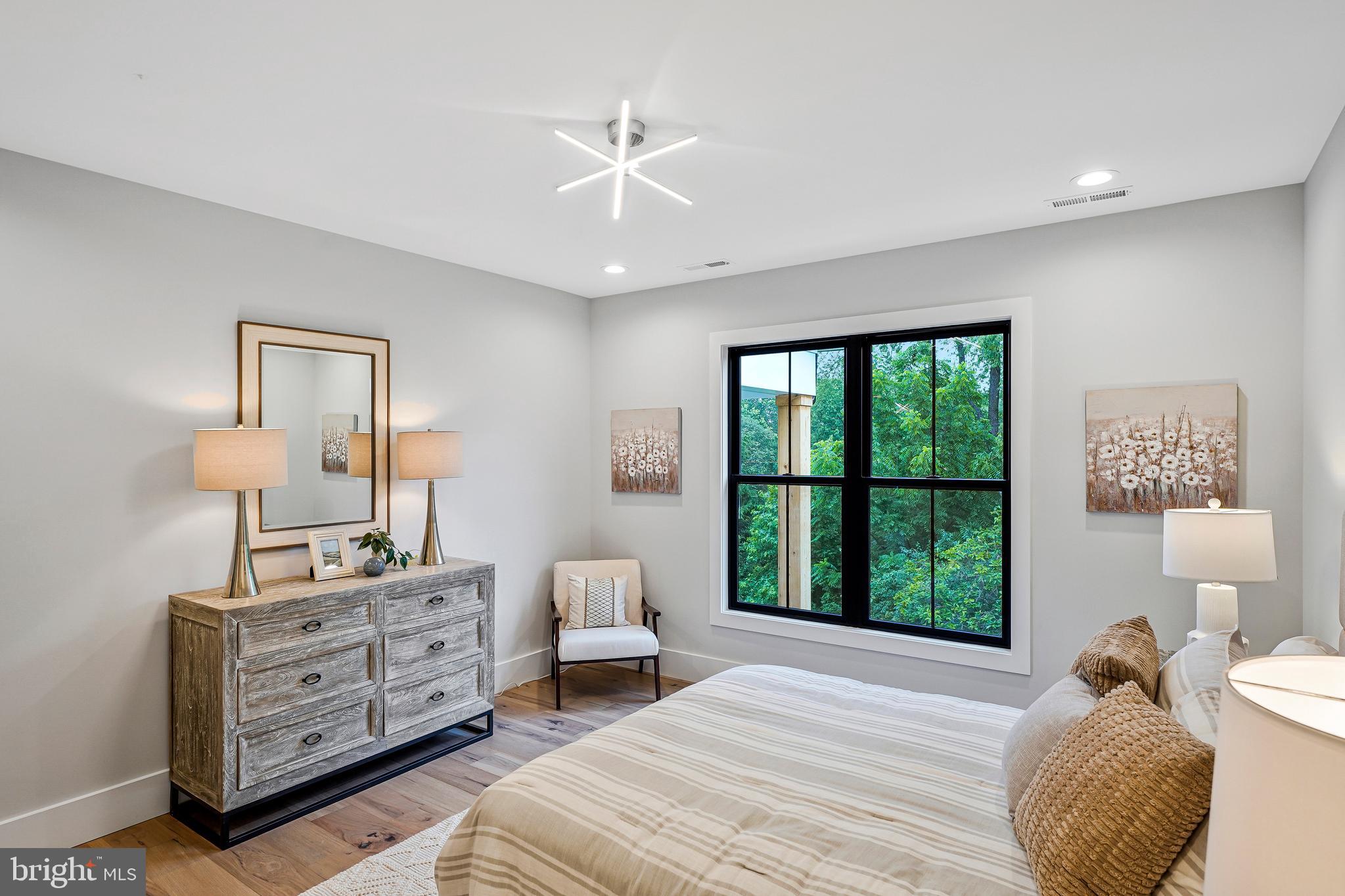 11410 Waples Mill Road Oakton, VA 22124 - Photo 30 of 104 a bedroom with furniture and a large window
