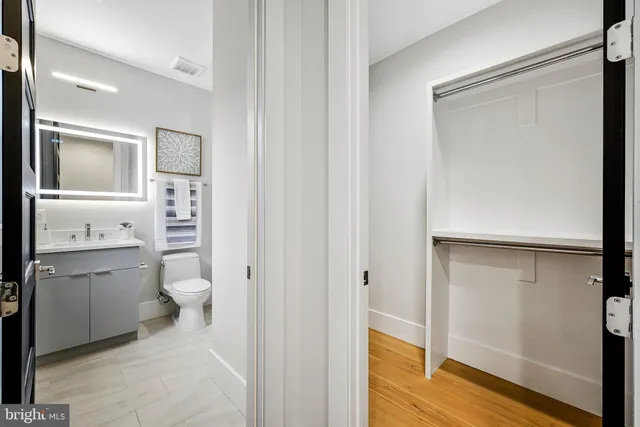 a bathroom with a toilet a sink and mirror