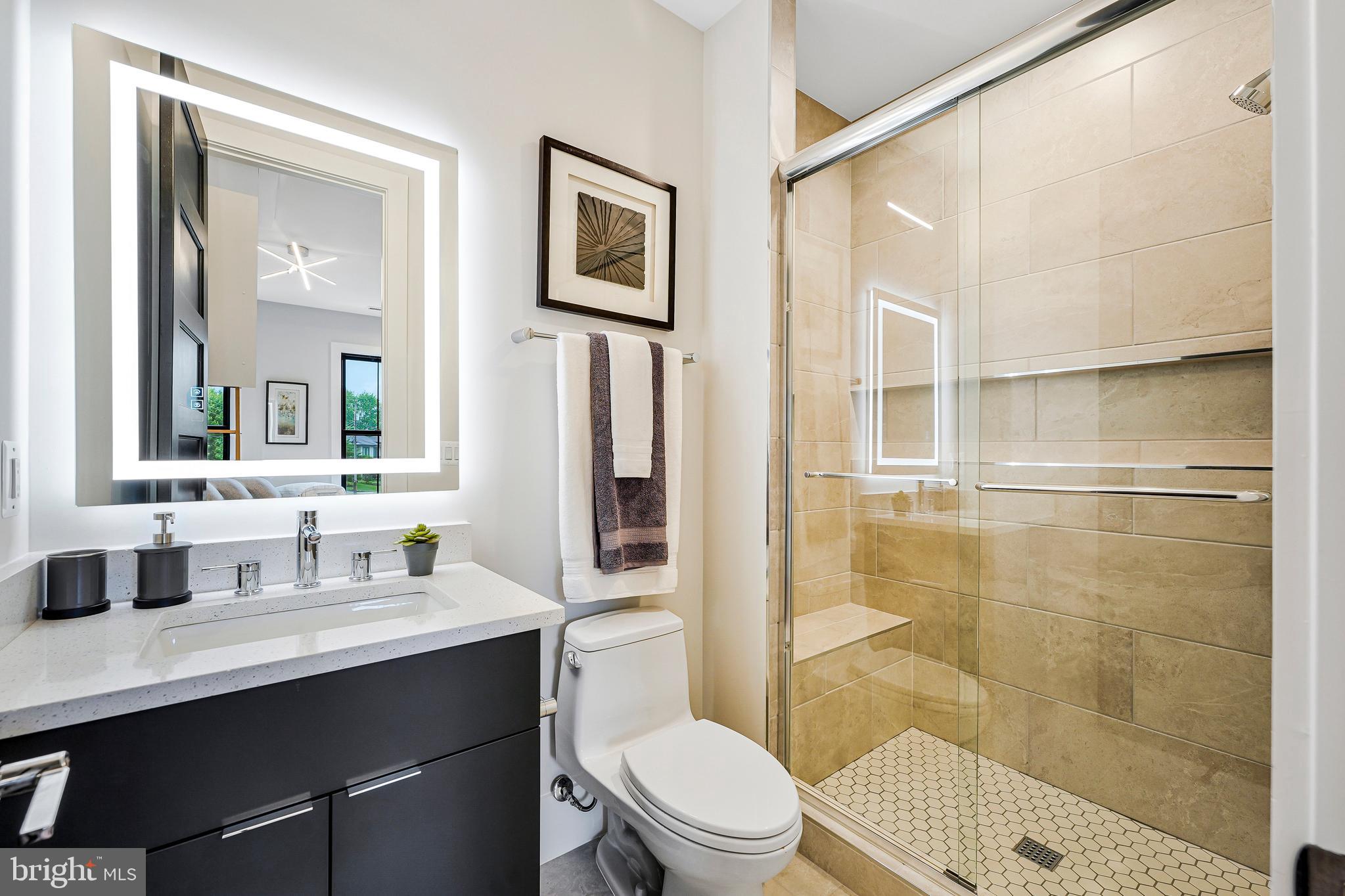 11410 Waples Mill Road Oakton, VA 22124 - Photo 35 of 104 a bathroom with a sink a toilet a shower and a mirror