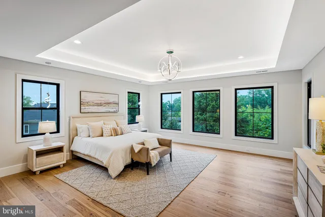 a spacious bedroom with a large bed and a large window