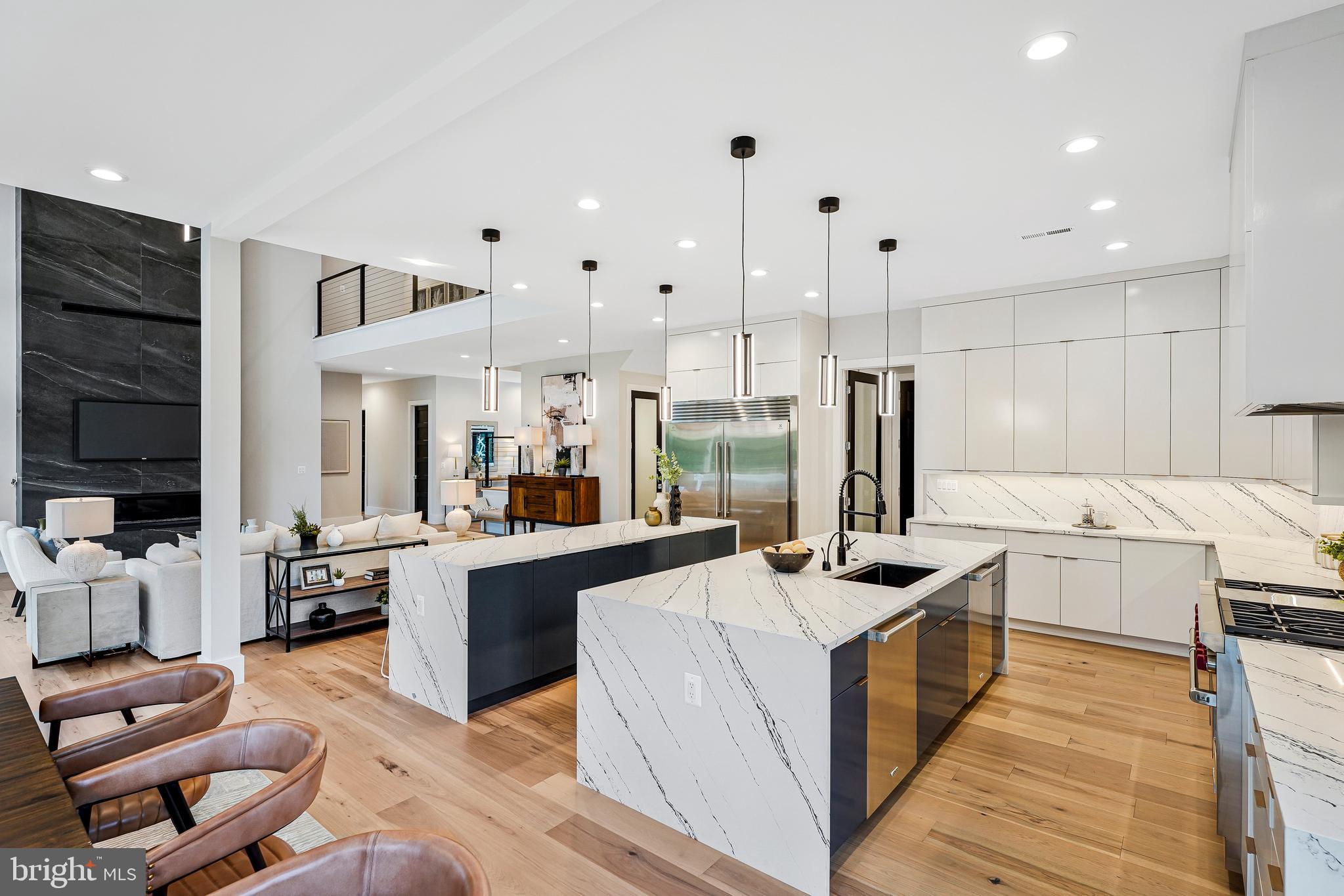 11410 Waples Mill Road Oakton, VA 22124 - Photo 42 of 104 a large kitchen with stainless steel appliances kitchen island granite countertop a lot of cabinets and couches with wooden floor