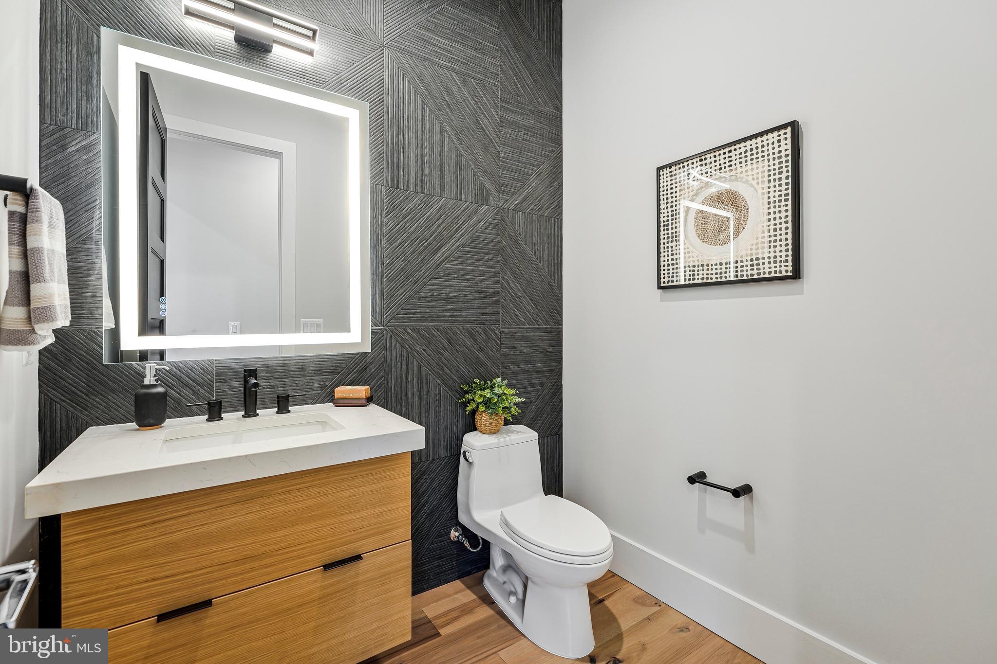 11410 Waples Mill Road Oakton, VA 22124 - Photo 66 of 104 a bathroom with a toilet a sink and mirror