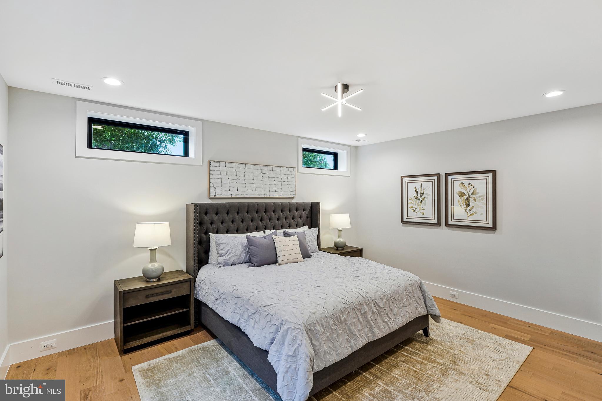 11410 Waples Mill Road Oakton, VA 22124 - Photo 88 of 104 a bedroom with a bed and a lamp