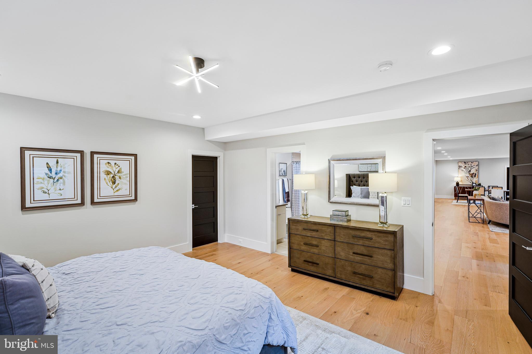 11410 Waples Mill Road Oakton, VA 22124 - Photo 89 of 104 a bedroom with a bed and a chandelier