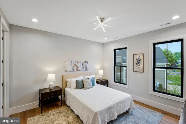a view of kitchen island with cabinets and wooden floor