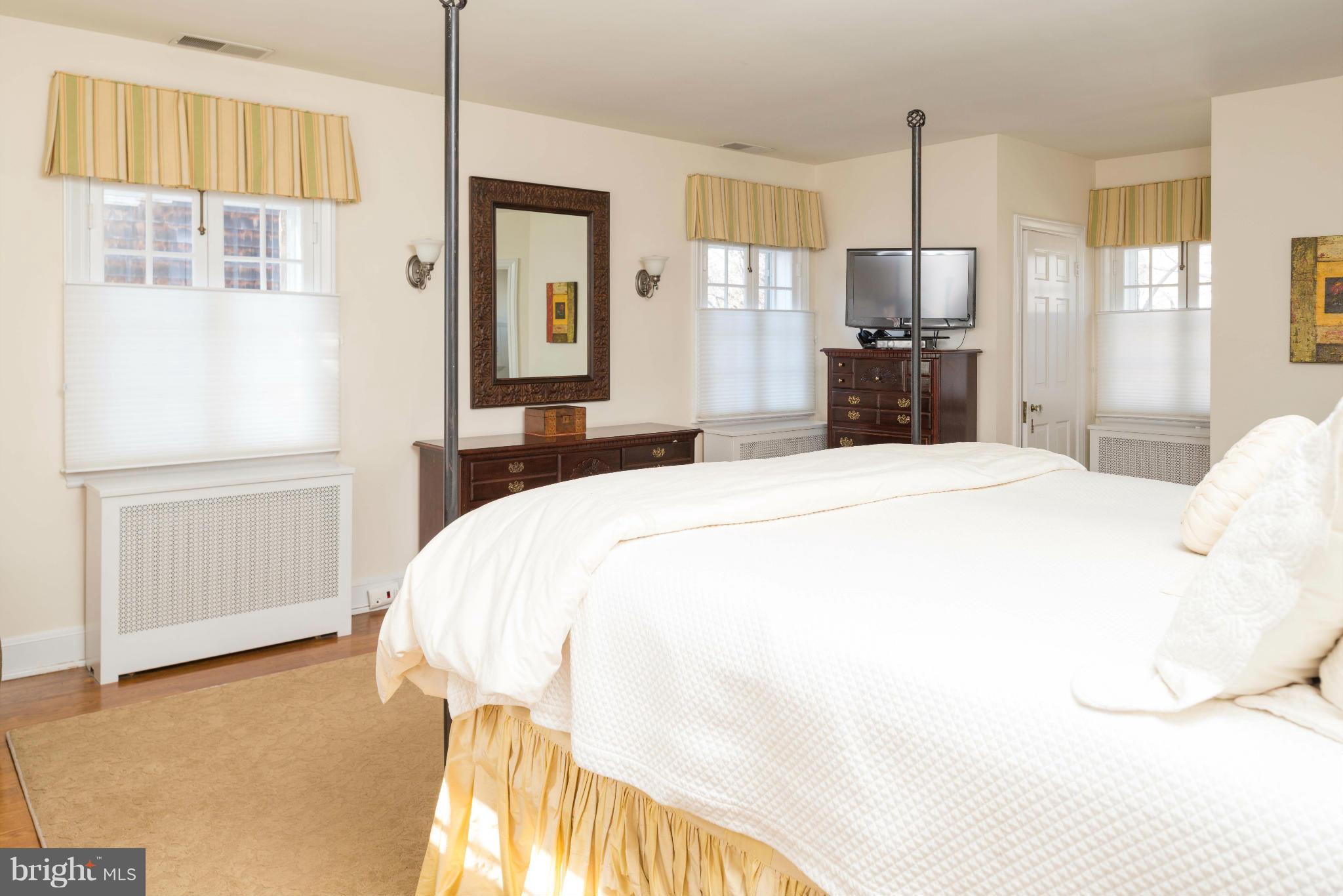 207 Witherspoon Road Baltimore, MD 21212 - Photo 15 of 28 a bedroom with a bed and wooden floor