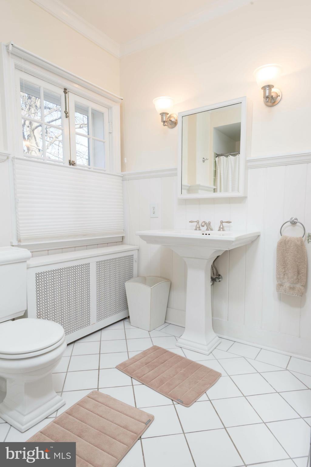 207 Witherspoon Road Baltimore, MD 21212 - Photo 17 of 28 a bathroom with a sink toilet and mirror