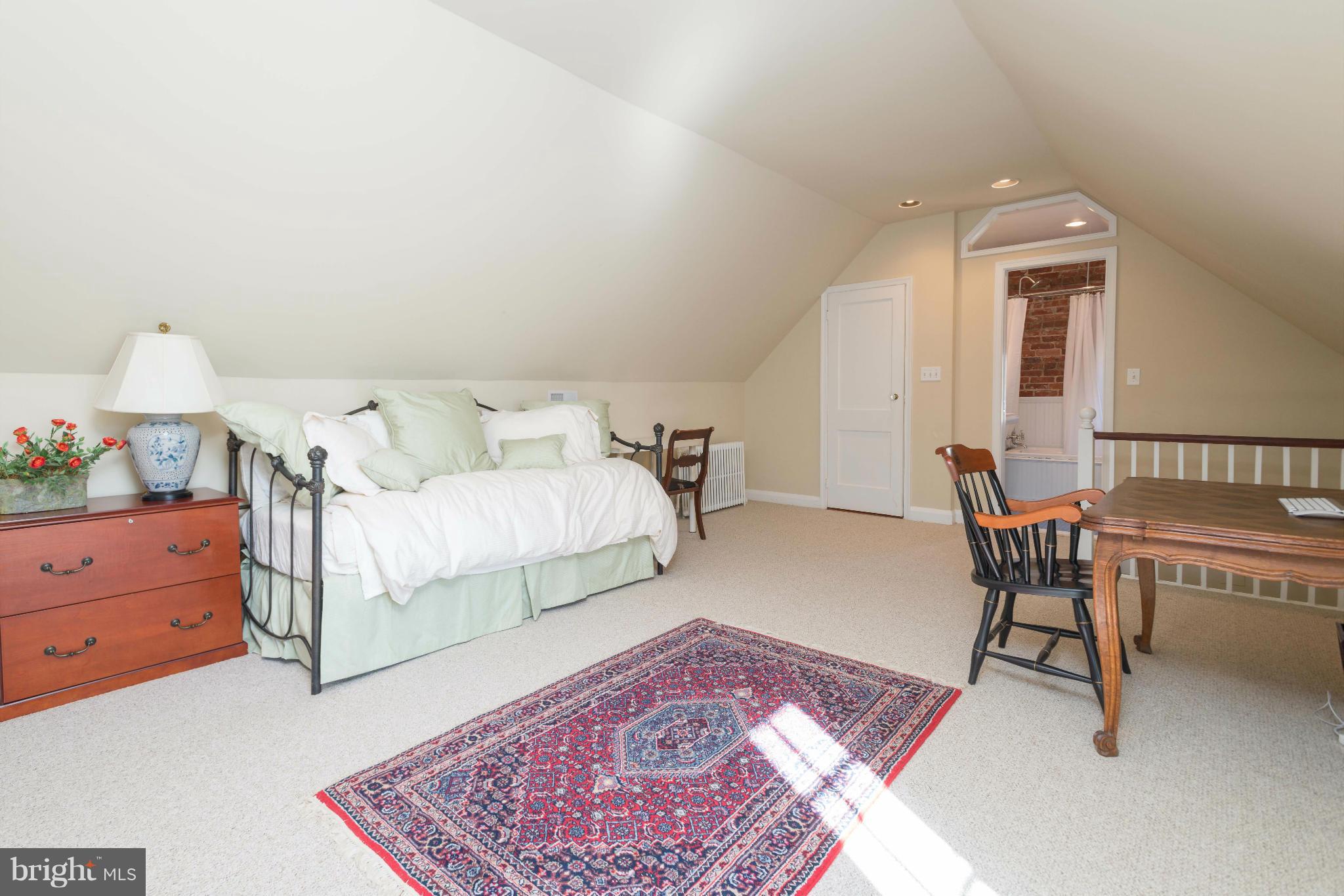 207 Witherspoon Road Baltimore, MD 21212 - Photo 25 of 28 a bedroom with a bed and a chandelier