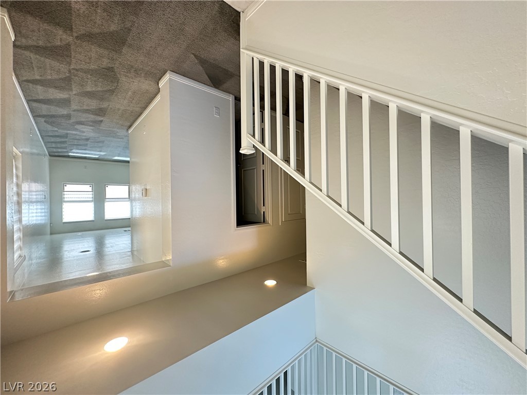 6784 Pivot Point Street Las Vegas, NV 89148 - Photo 8 of 27 Clean lines define this multi-level space, showcasing both sleek flooring and comfortable carpeting.