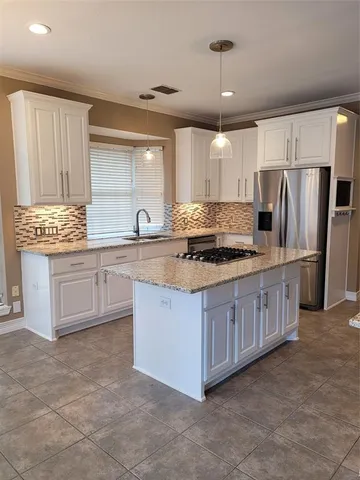 a large kitchen with kitchen island a sink stainless steel appliances and cabinets