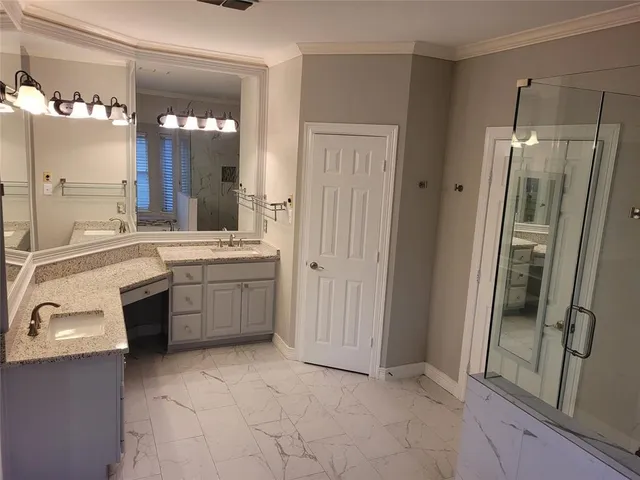 a bathroom with a shower and a sink