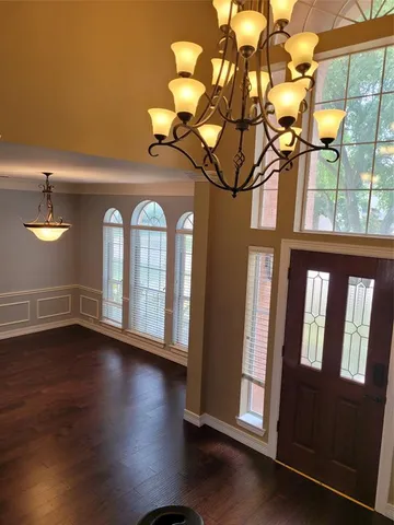 a view of an entryway with wooden floor