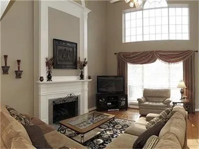 a living room with furniture fireplace and window