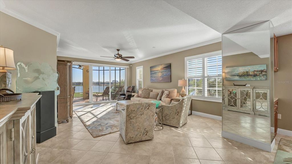 6414 Water Crest Way, Unit 302 Lakewood Ranch, FL 34202 - Photo 11 of 74 a living room with fireplace furniture and a large window