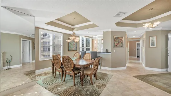 a view of a dining room with furniture chandelier and wooden floor