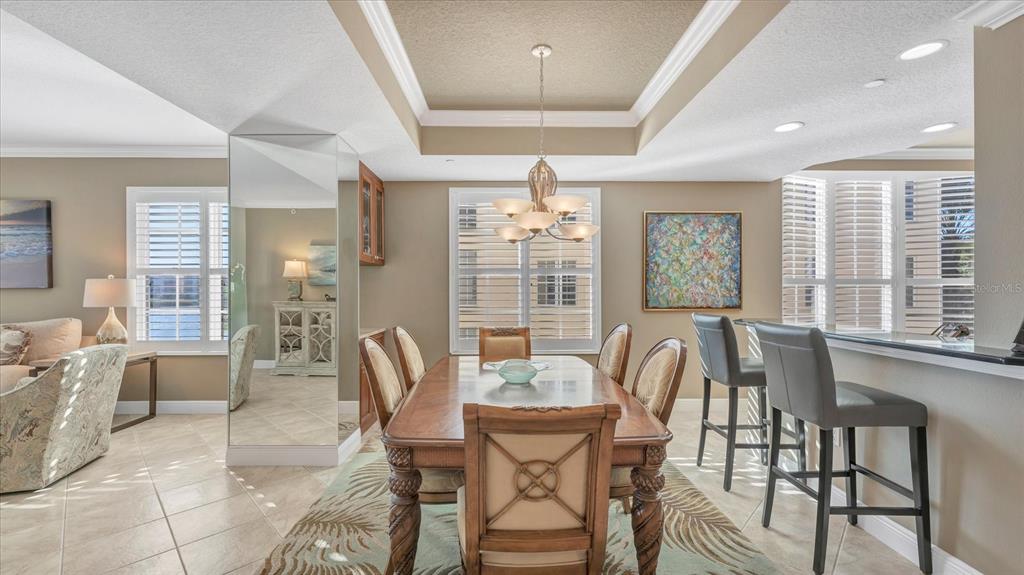 6414 Water Crest Way, Unit 302 Lakewood Ranch, FL 34202 - Photo 17 of 74 a view of a dining room with furniture window and outside view