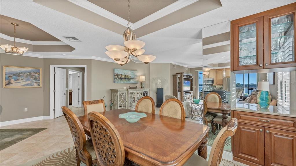 6414 Water Crest Way, Unit 302 Lakewood Ranch, FL 34202 - Photo 19 of 74 a view of a dining room with furniture chandelier and wooden floor