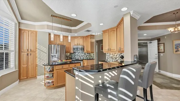 a kitchen with granite countertop a sink and a stove top oven