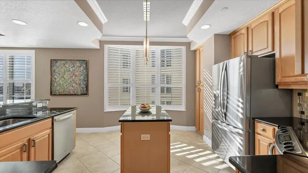 a bedroom with a large bed and a ceiling fan