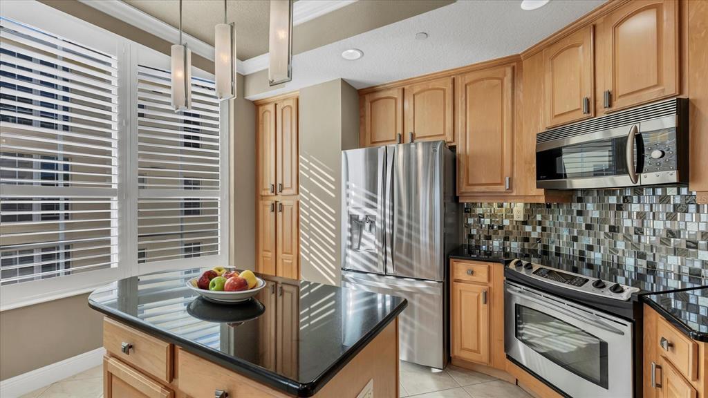 6414 Water Crest Way, Unit 302 Lakewood Ranch, FL 34202 - Photo 26 of 74 a kitchen with stainless steel appliances granite countertop a sink stove and refrigerator