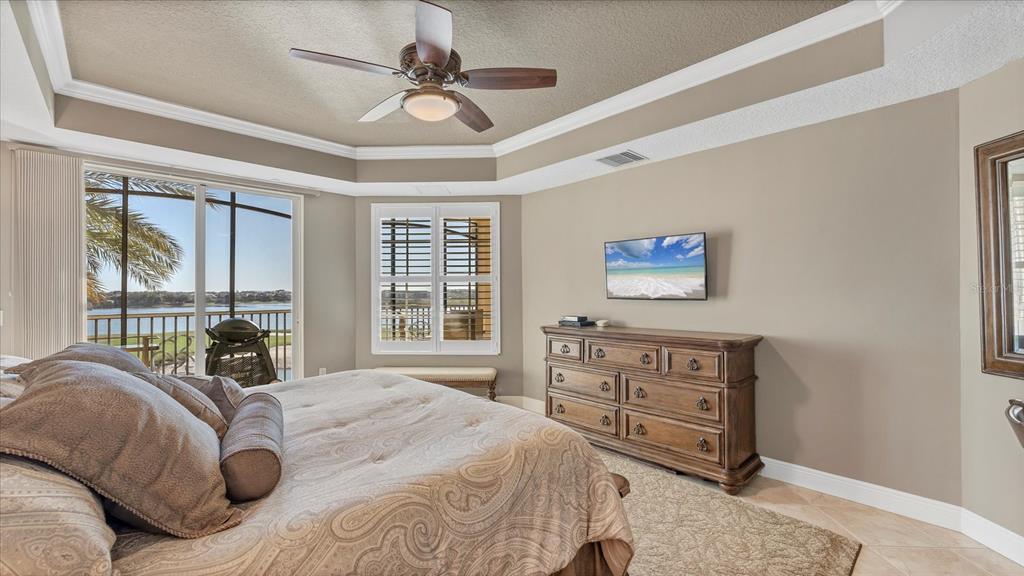 6414 Water Crest Way, Unit 302 Lakewood Ranch, FL 34202 - Photo 28 of 74 a bedroom with a large bed and a large window