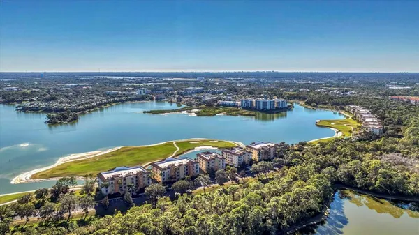an aerial view of ocean residential house with outdoor space and lake view in back