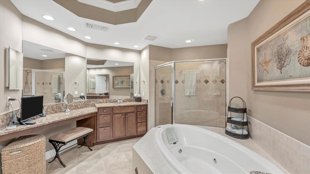 6414 Water Crest Way, Unit 302 Lakewood Ranch, FL 34202 - Photo 33 of 74 a bathroom with a tub a sink double vanity and a shower