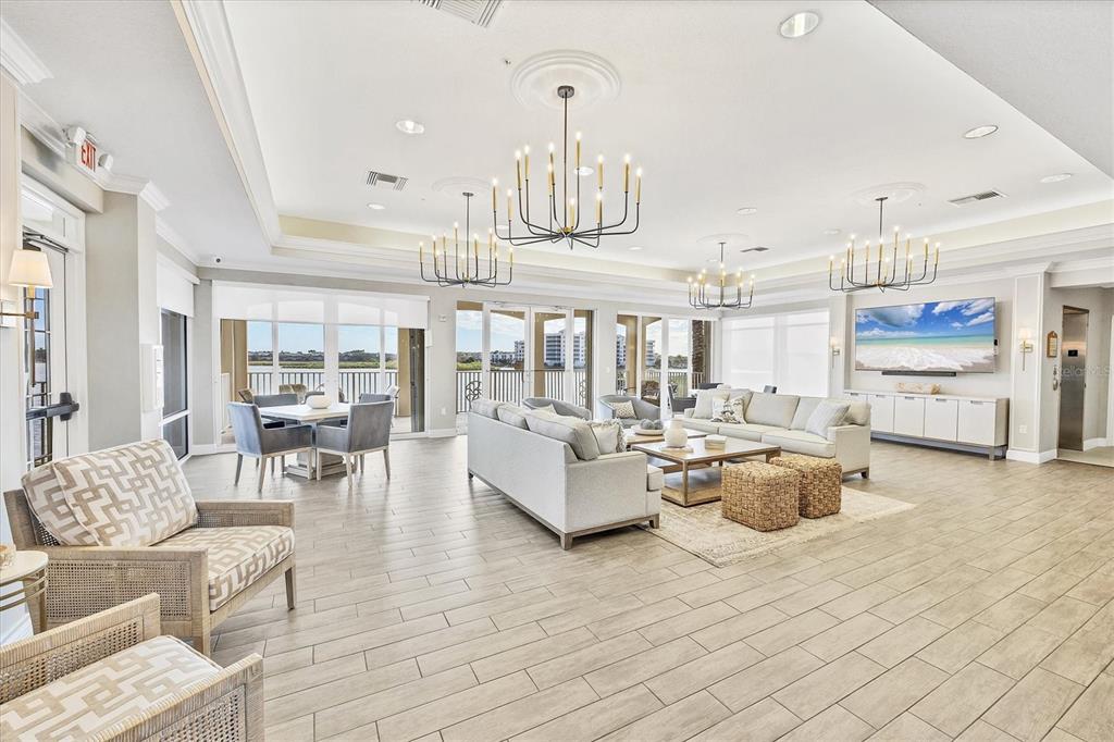 6414 Water Crest Way, Unit 302 Lakewood Ranch, FL 34202 - Photo 59 of 74 a living room with furniture and a chandelier
