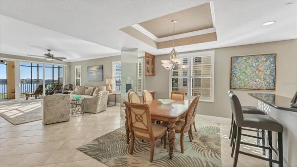 a living room with furniture and floor to ceiling windows