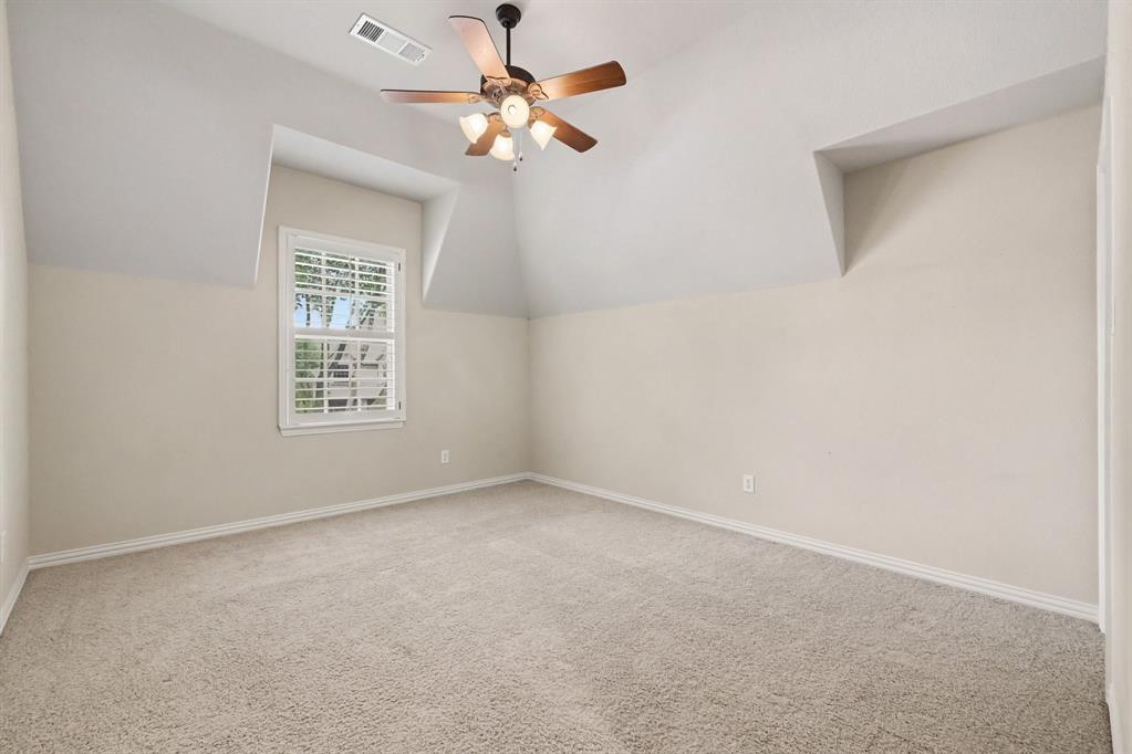 408 Blue Ridge Court Allen, TX 75013 - Photo 27 of 31 Vaulted ceiling with a ceiling fan, plush carpet flooring, window with shutters, and architectural dormer details