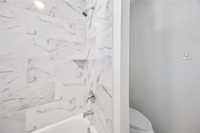 a bathroom with a bathtub and shower