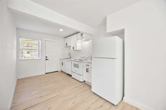 a kitchen with stainless steel appliances a refrigerator sink and cabinets