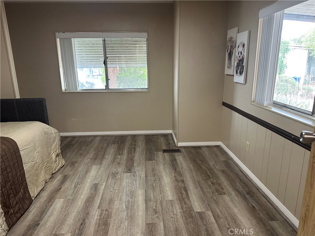 27701 Murrieta Road, Unit 268 Menifee, CA 92586 - Photo 15 of 24 a bedroom with a bed and wooden floor