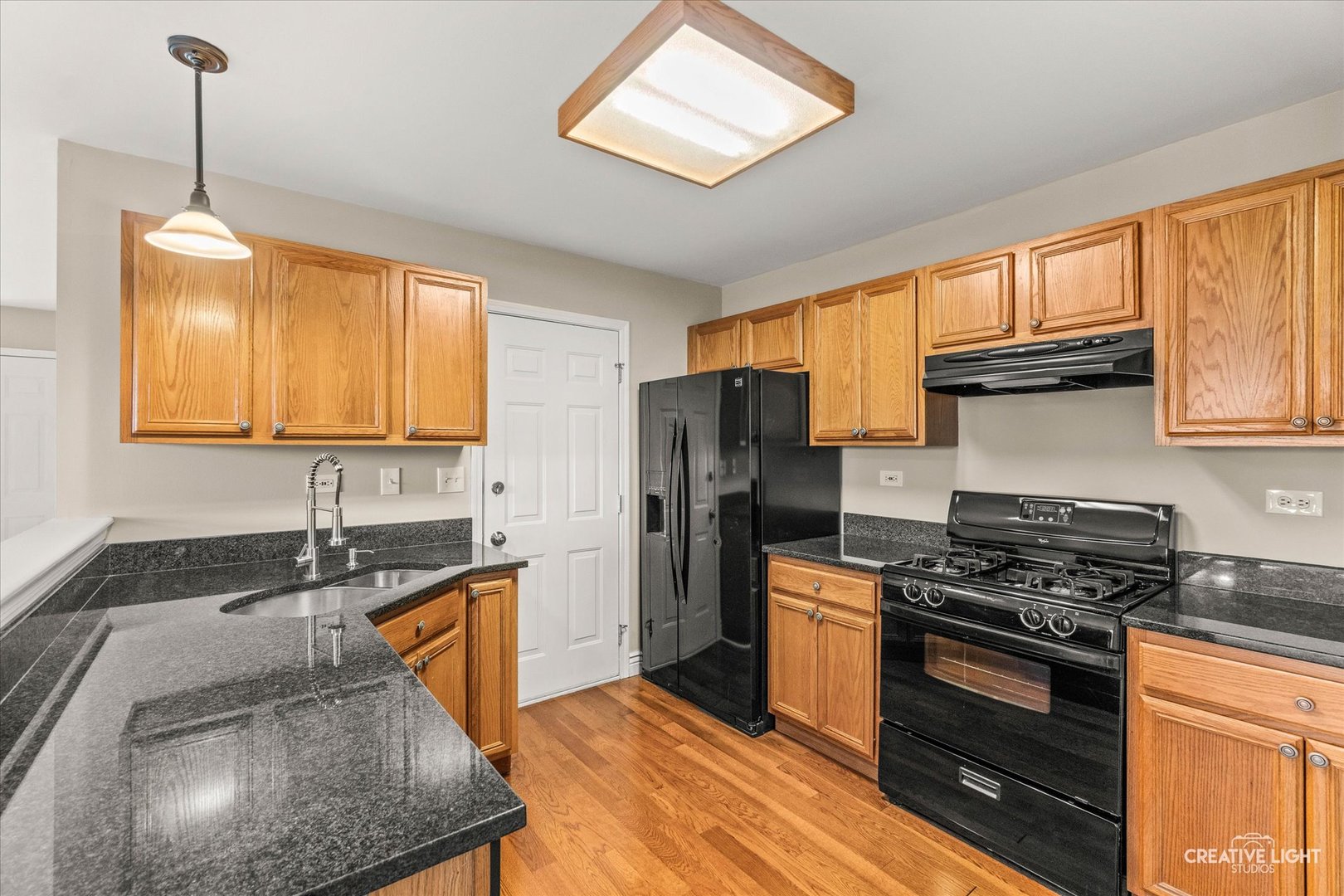 862 North 1st Street, Unit 862 Elburn, IL 60119 - Photo 7 of 32 a kitchen with granite countertop a sink stainless steel appliances and cabinets