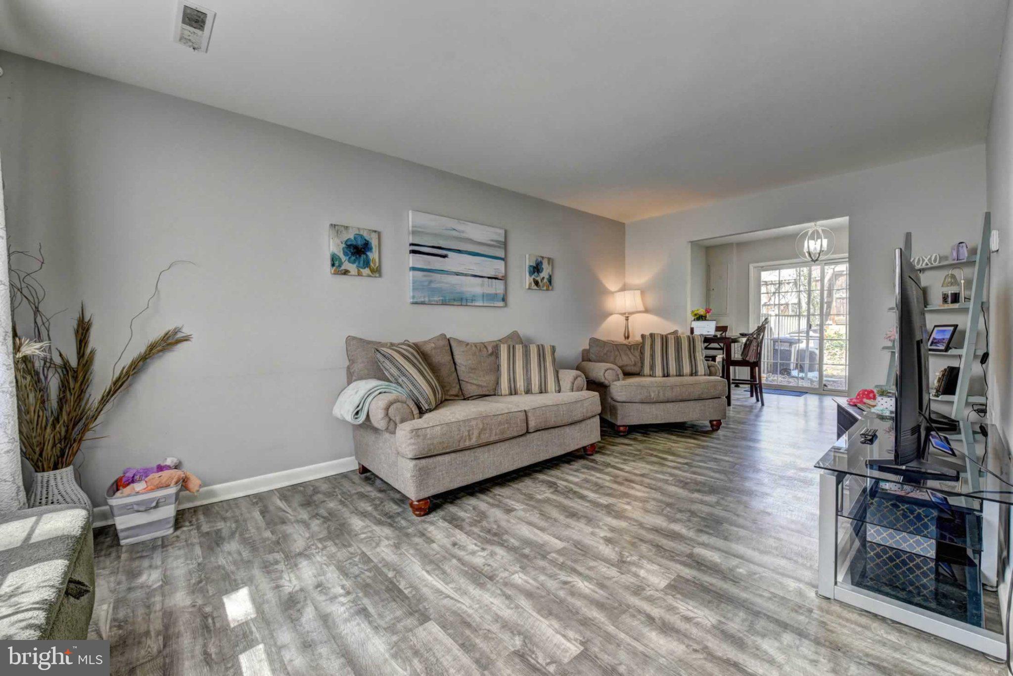 2226 Gunsmith Square Reston, VA 20191 - Photo 5 of 35 a living room with furniture and a flat screen tv