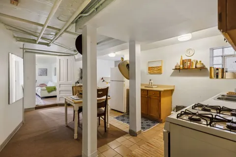 a bedroom with furniture and a large window