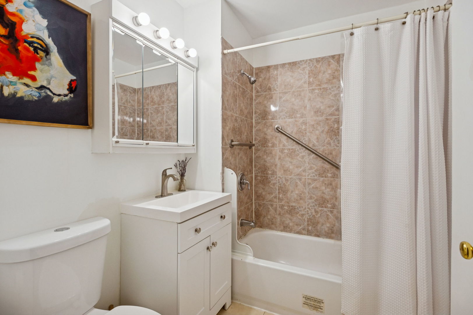 3226 West Thomas Street Chicago, IL 60651 - Photo 5 of 28 a bathroom with a sink a mirror a toilet and a shower