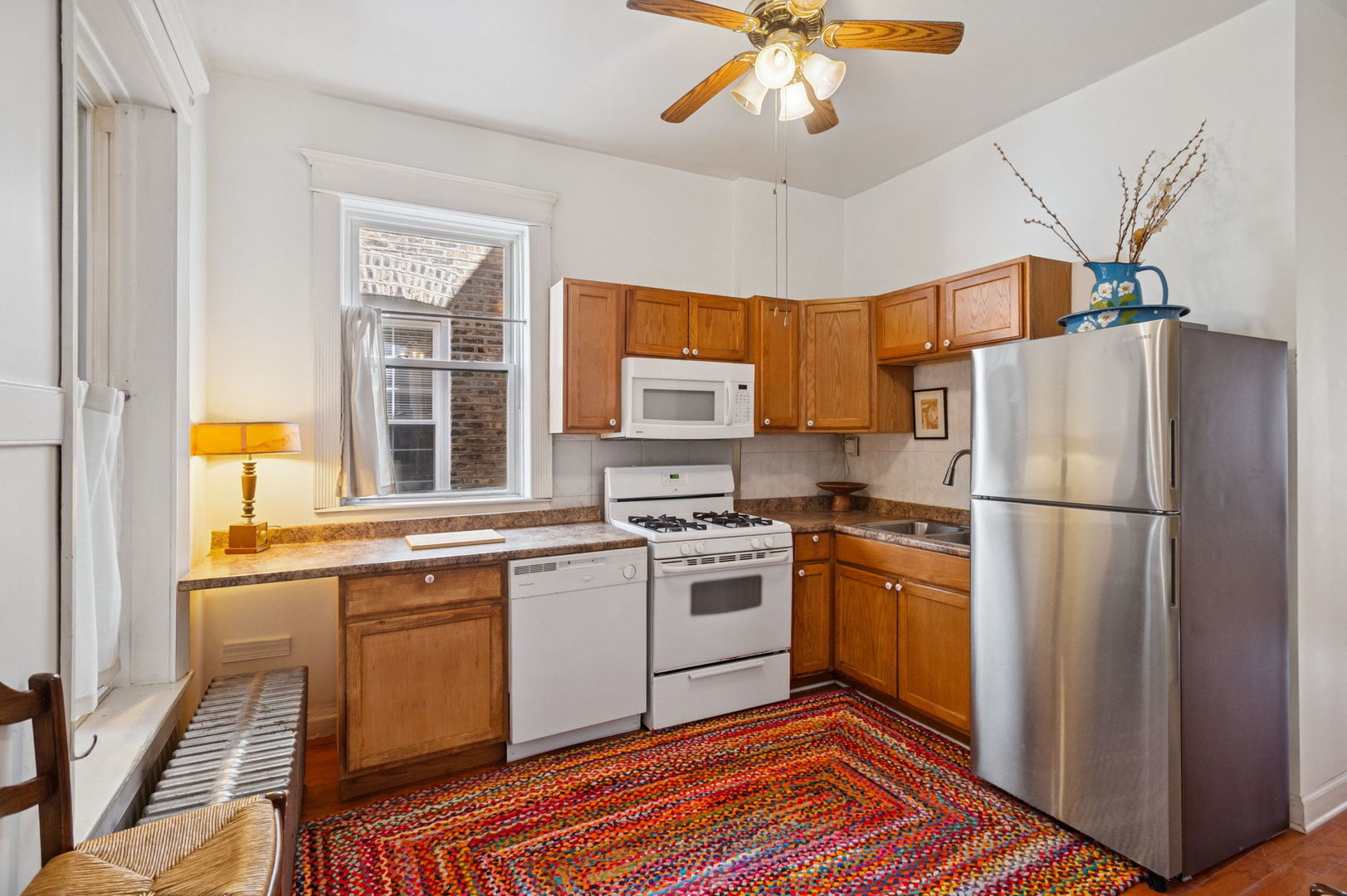 3226 West Thomas Street Chicago, IL 60651 - Photo 6 of 28 a kitchen with stainless steel appliances granite countertop a refrigerator a sink a stove and white cabinets