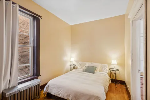 a bedroom with a bed and a window