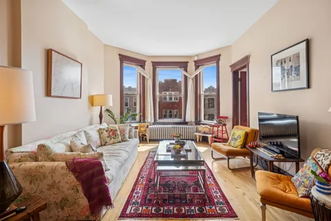 a living room with furniture and a rug