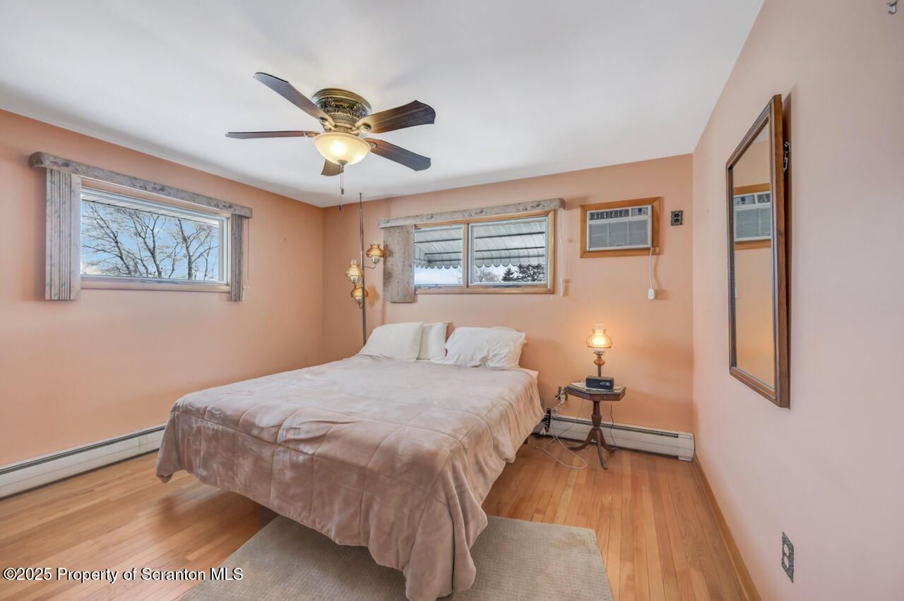 216 Prospect Street Dunmore, PA 18512 - Photo 16 of 81 a bedroom with a bed and a chandelier