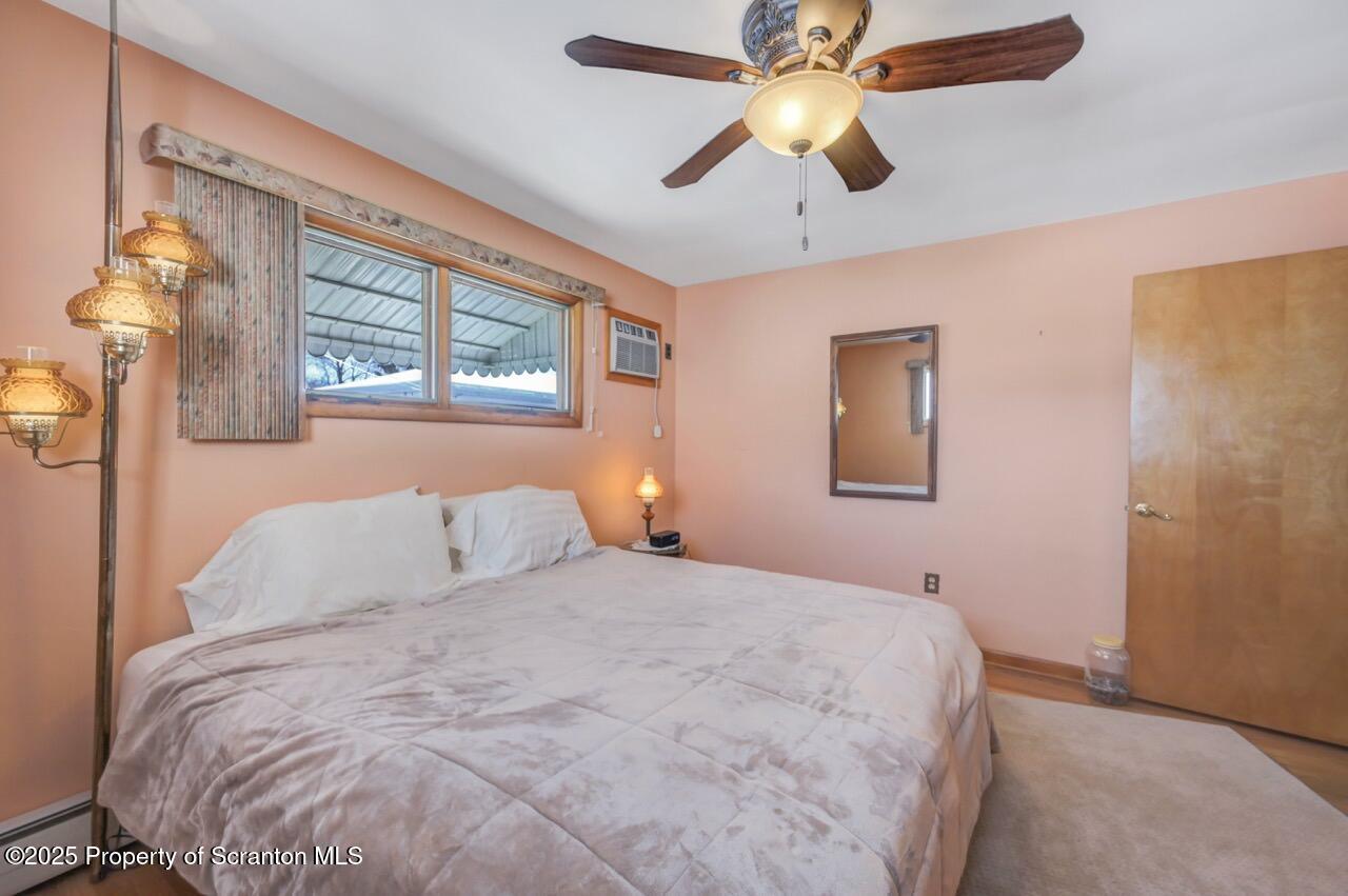 216 Prospect Street Dunmore, PA 18512 - Photo 17 of 81 a bedroom with a large bed and a chandelier fan