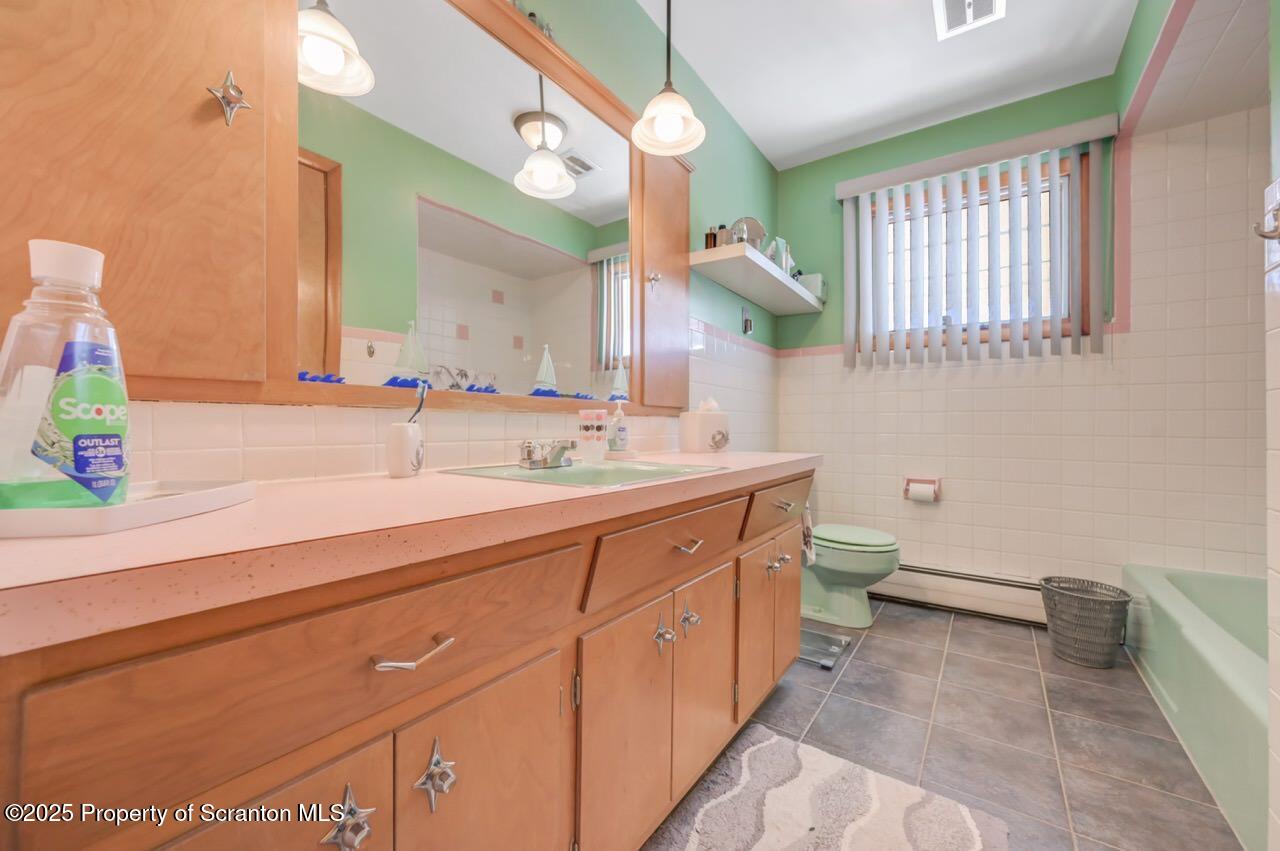 216 Prospect Street Dunmore, PA 18512 - Photo 19 of 81 a spacious bathroom with a double vanity sink a mirror and a