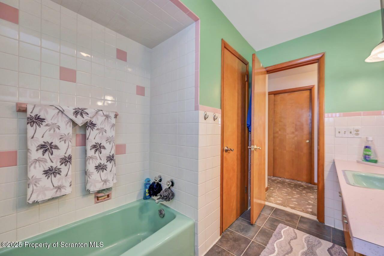 216 Prospect Street Dunmore, PA 18512 - Photo 21 of 81 a bathroom with a bathtub a shower and a sink